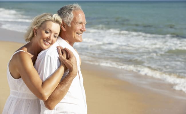 Comforted-Couple-At-Beach-Because-Of-Cancer-Insurance