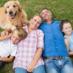 Family-Outside-On-The-Grass-With-Dog