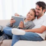 Couple-Reviewing-Cancer-Insurance-Quotes-On-Couch