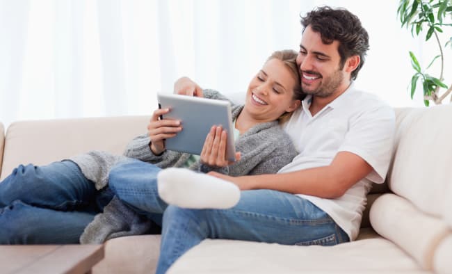 Couple-Reviewing-Cancer-Insurance-Quotes-On-Couch