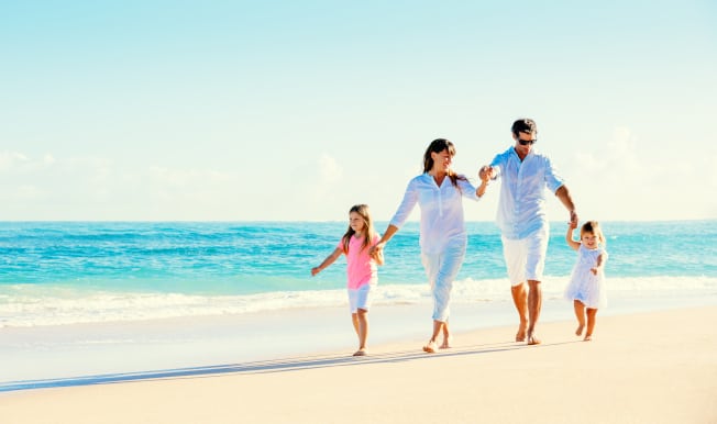 Family-Waling-On-The-Beach-Holding-Hands
